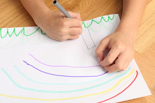 istock Boy drawing picture at wooden table, closeup 2216470375