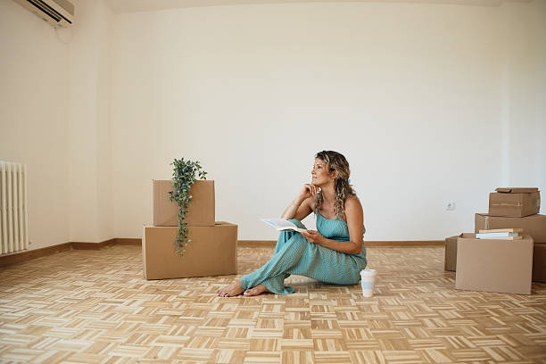 istock Single woman moving into new home 2216471608