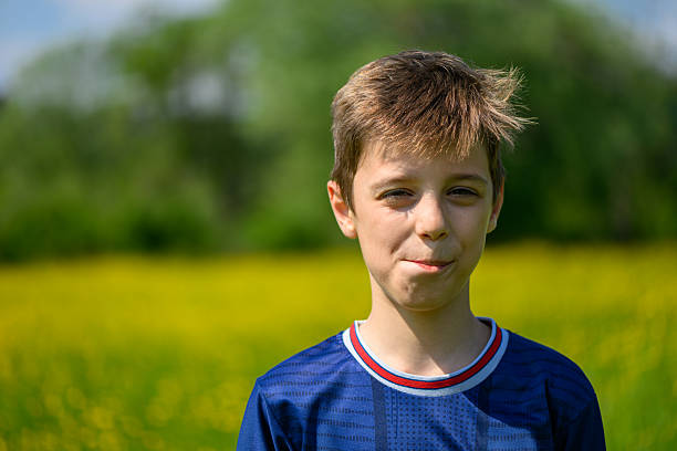 istock The boy is posing in Field with Meadow Buttercup (Ranunculus acris). 2216471669