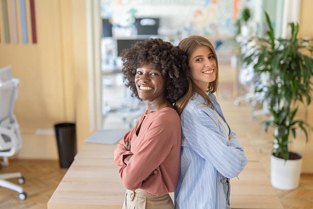 istock Two confident women showing smiles in a creative work area. 2216473650