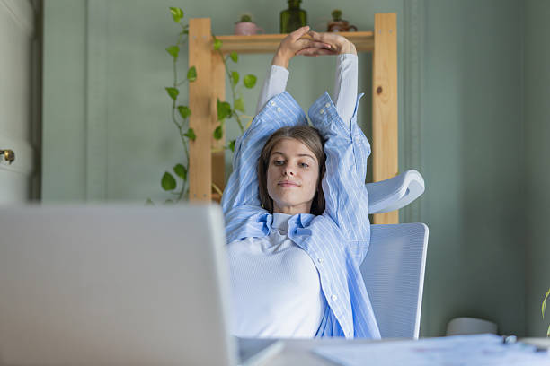 istock Content individual stretching back comfortably at workspace 2216473830