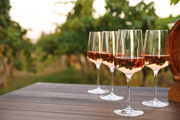 istock Tasty wine in glasses on wooden table outdoors. Space for text 2216480158