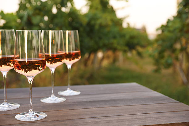 istock Tasty wine in glasses on wooden table outdoors. Space for text 2216480548