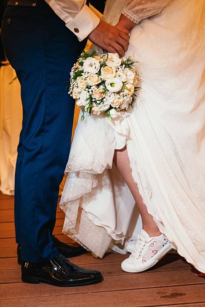 istock Bride and Groom with Bouquet and Sneakers at Wedding 2216481272