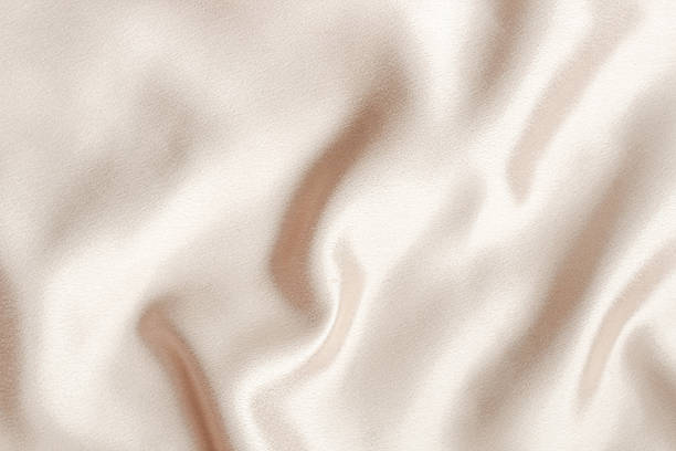 istock Elegant silk fabric drapes smoothly under soft lighting in a modern interior setting 2216482951