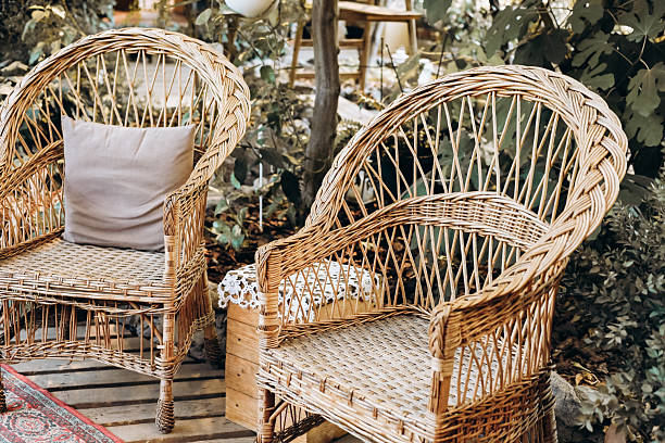 istock Cozy seating arrangement in a natural setting with wicker chairs and greenery 2216483139