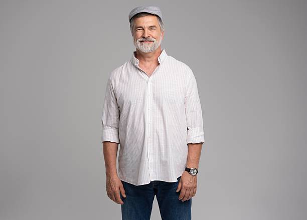 istock Friendly grey beard aged man in cap wear white shirt isolated on grey 2216484157