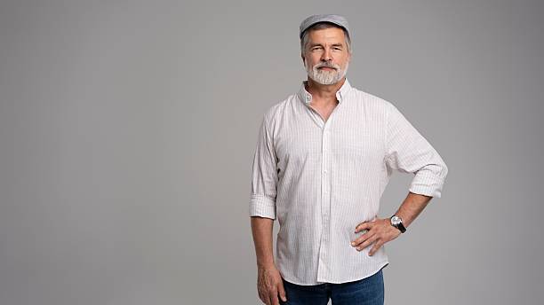 istock Friendly grey beard aged man in cap wear white shirt isolated on grey 2216484189