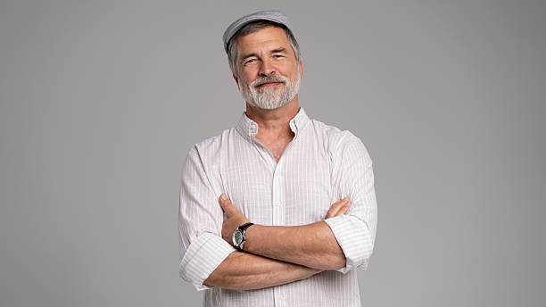 istock Friendly grey beard aged man in cap wear white shirt isolated on grey 2216484203