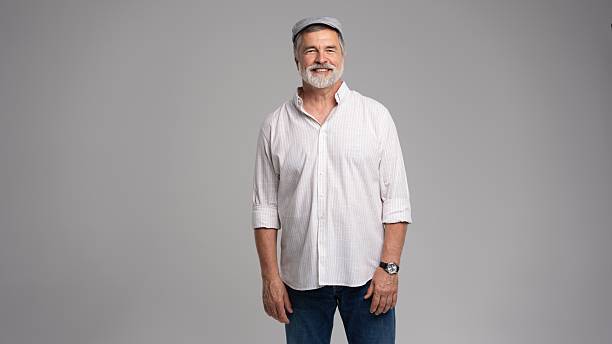 Friendly grey beard aged man in cap wear white shirt isolated on grey background