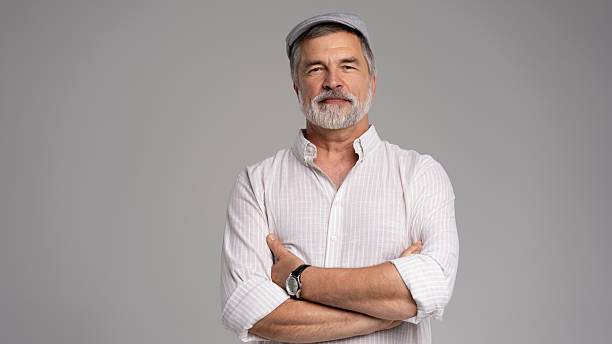 istock Friendly grey beard aged man in cap wear white shirt isolated on grey 2216484216