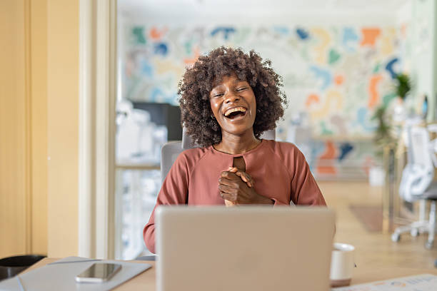 istock Joyful young woman smiling and celebrating during video call 2216485883