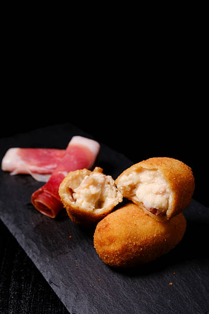 istock Open croquette revealing creamy filling with serrano ham 2216486719