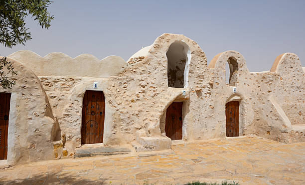 KSAR HADADA, TUNISIA - MARCH 03, 2024: Traditional ancient Berber multi-level ghorfas adapted for hotel in village of Ksar Hadada. Timeless Tunisian architecture