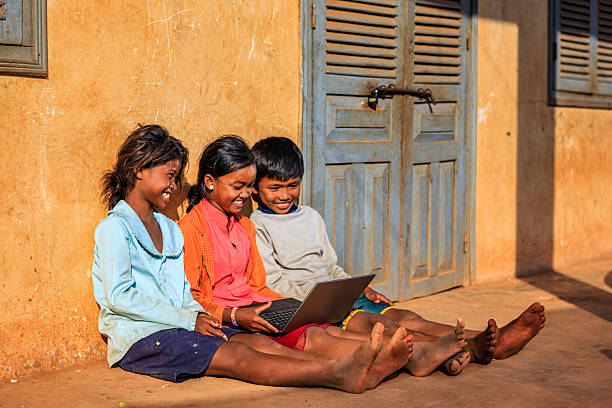 istock Happy Cambodian children using laptop on a schoolyard, Cambodia 2216488576