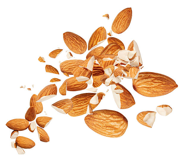 istock Almond nuts  levitating in air isolated on white.  Falling crushed almonds nuts. Cracked Almonds is torn to pieces explosion 2216490658