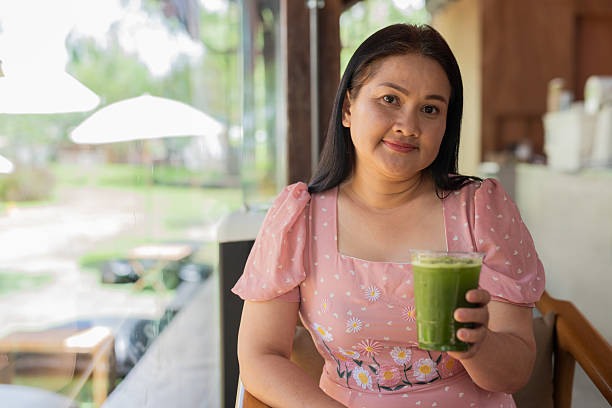 istock Mature Asian woman sitting inside cafe restaurant 2216492870