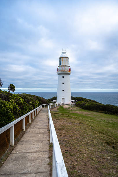 Cape Otway Lightstation, located along the Great Ocean Road in Australia, stands on a cliff overlooking the ocean, offering scenic coastal views