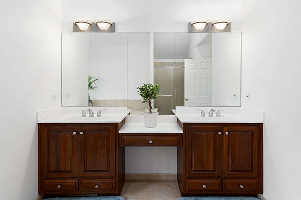 istock A bathroom with wood cabinets and white countertop. 2216494704