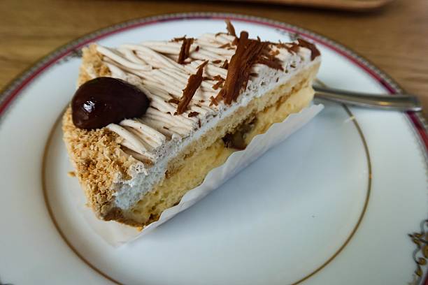 istock chestnut cream sponge cake on a old traditional plate with copy space 2216495336