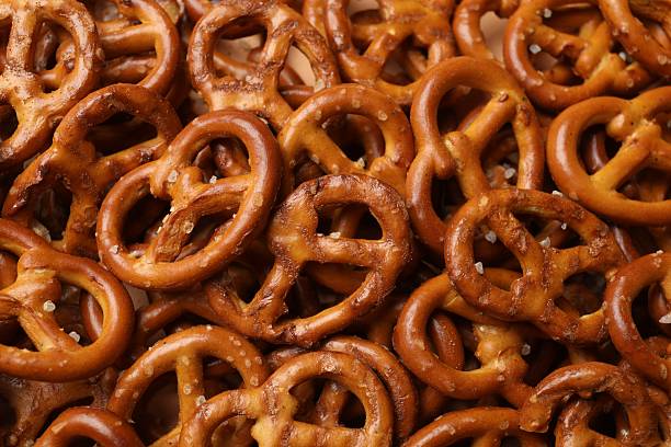 istock Many delicious pretzel crackers as background, top view 2216495767