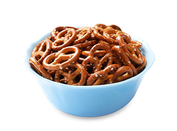 istock Delicious pretzel crackers in bowl isolated on white 2216495782