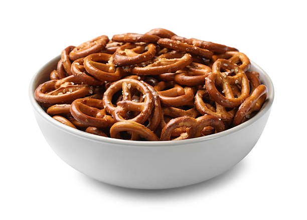 istock Delicious pretzel crackers in bowl isolated on white 2216495808