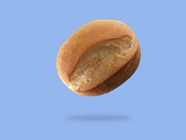 Decorated bread rolls on gray striped napkin on wooden table
