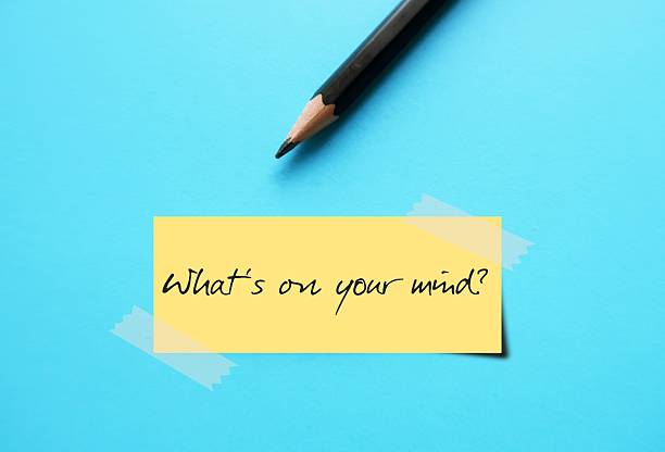 istock Stick Note on blue background with text written - WHAT'S ON YOUR MIND? -  a way of asking someone What are you thinking about? or What topic is occupying your mind right now? 2216497576