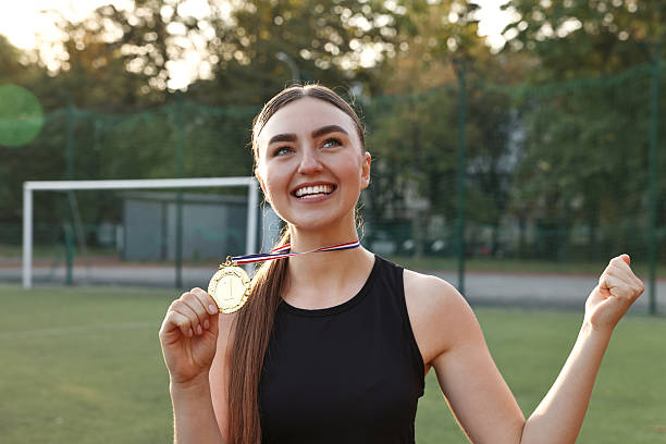 istock Happy winner with golden medal at stadium 2216498189