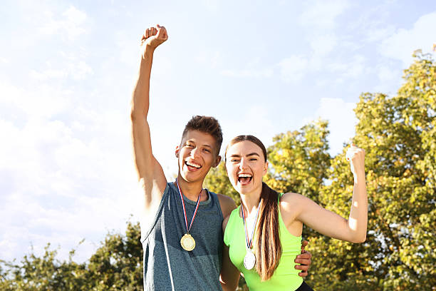istock Happy winners with medals outdoors on sunny day 2216498263