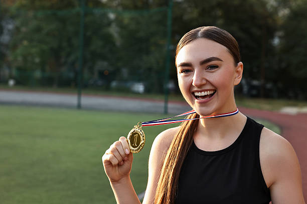 istock Happy winner with golden medal at stadium. Space for text 2216498320