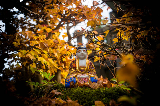 istock Buddha statue in a maple bonsai forest in autumn, meditation. 2216500468