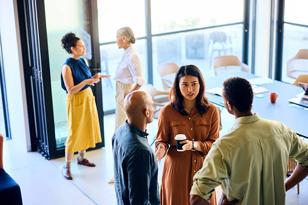 istock Business colleagues talking in office on coffee break, high angle 2216501135
