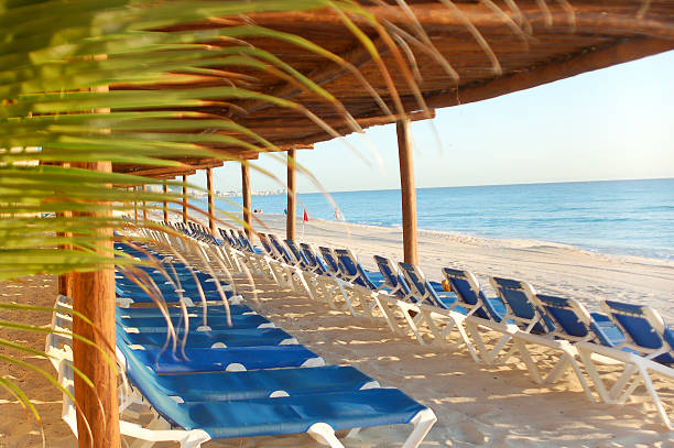 A Mexican holiday villa overlooks the turquoise Caribbean Sea on the beach in Cancun, Mexico.