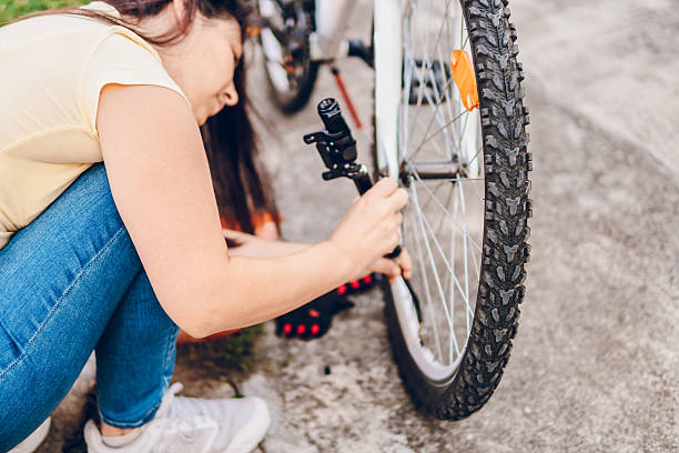 istock Woman repairing the bicycle 2216501889