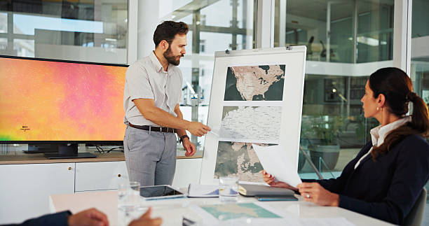 istock Presentation, business man and map on whiteboard for weather pattern, target market and marketing geography. Screen, meeting and team speaker in office with climate data for planning global campaign 2216502437