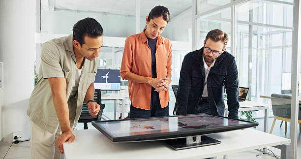 istock Discussion, monitor and group with interactive display, collaboration and planning for windmill design. Teamwork, global and people with tech for map, wind turbine and renewable energy for world 2216502466
