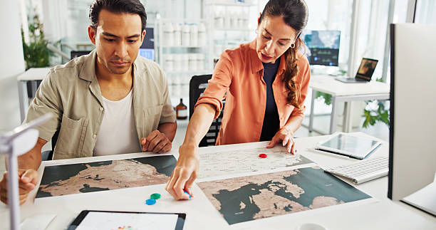 istock Energy, teamwork or people with map in office for wind farm layout, project planning or power development. Sustainability, engineer or pin marker for turbine location, site selection or data analysis 2216502469