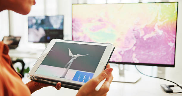 istock Screen, engineer and employee with tablet, hands and plan for windmill design, online and renewable energy. Office, designer and person with tech for wind turbine, economic benefits and eco friendly 2216502496