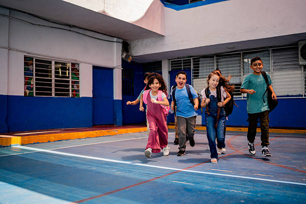 istock Child students running on school patio 2216504817