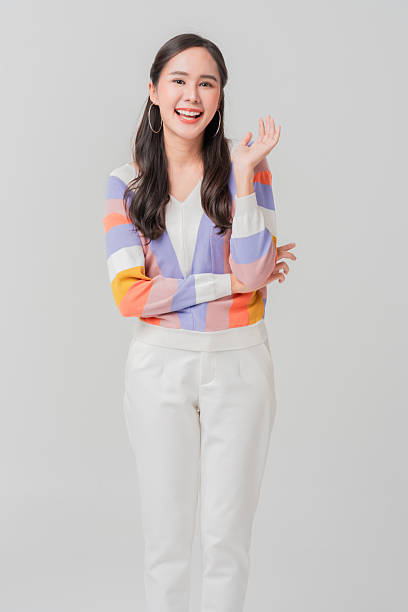 smiling cheerful asian woman in trendy casual cloth studio portrait shot on plain background