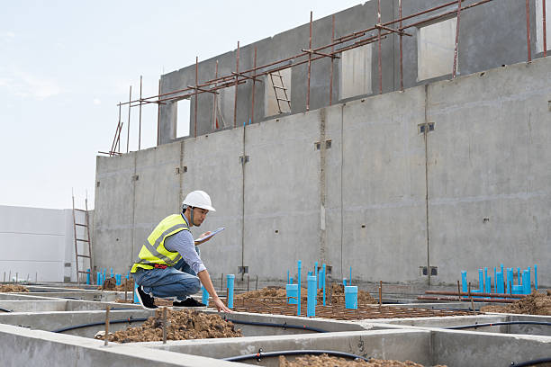istock Construction site. Civil engineer. Network of pipes. Plumber. Construction engineer supervising construction work at construction site. Plumber worker working in sewer pipes area at job site 2216507451