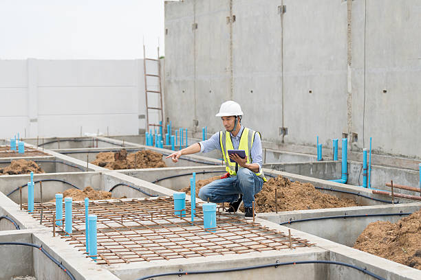 istock Construction site. Civil engineer. Network of pipes. Plumber. Construction engineer supervising construction work at construction site. Plumber worker working in sewer pipes area at job site 2216507456