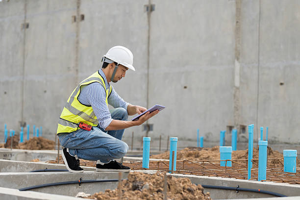 istock Construction site. Civil engineer. Network of pipes. Plumber. Construction engineer supervising construction work at construction site. Plumber worker working in sewer pipes area at job site 2216507463