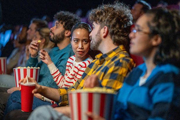 istock Audience members enjoy snacks and engage in conversations during a film screening 2216507645