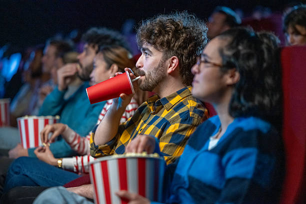 istock Spectators enjoying snacks and drinks in a movie theater 2216507657