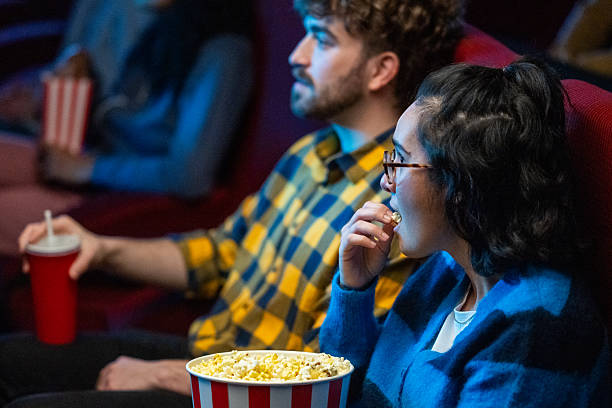 istock Watching a movie, enjoying popcorn and drinks 2216507714