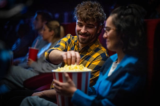 istock Lighthearted Moviegoers: A Couple's Popcorn Adventure 2216507800
