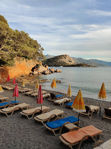 istock deck chairs and umbrellas on the sea beach in summer 2216510744